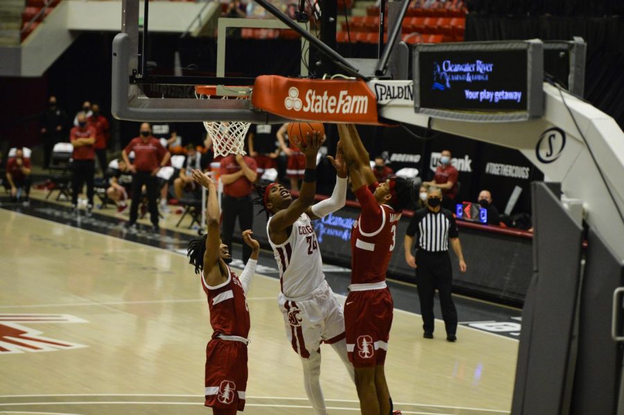 Sophomore guard Noah Williams goes for a layup between Stanford’s junior guard Bryce Wills and freshman forward Ziaire Williams during the matchup Saturday afternoon in Beasley Coliseum.
