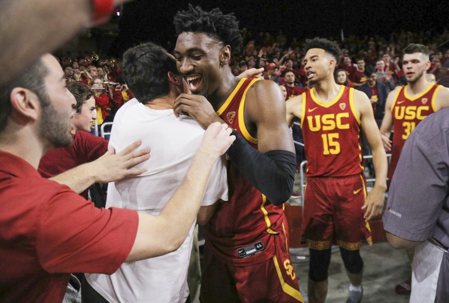 USCs+Jonah+Mathews%2C+middle%2C+celebrates+with+fans+after+making+a+game-winning+three-pointer+to+beat+UCLA+on+March+7%2C+2020.
