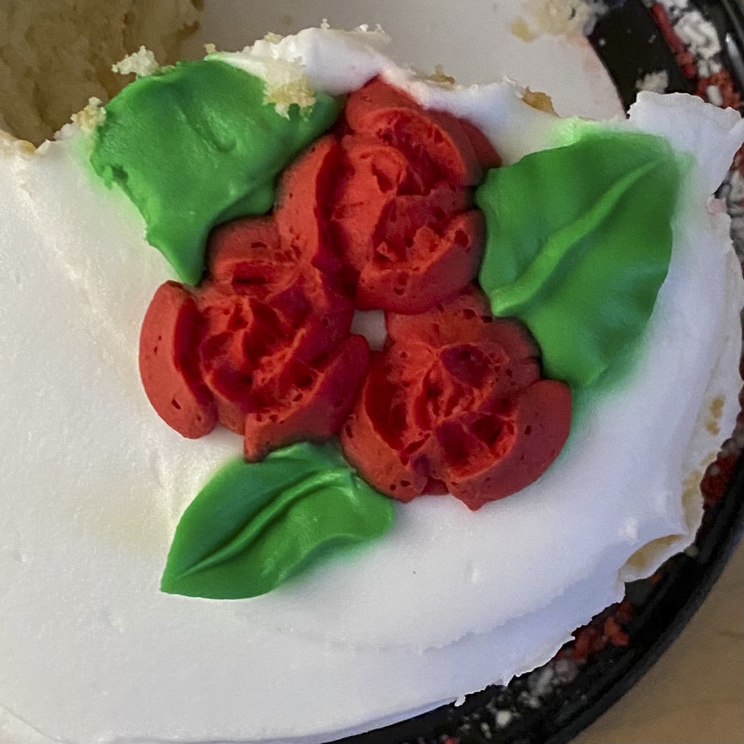 White cake with rose decor with perfect consistency of frosting. 