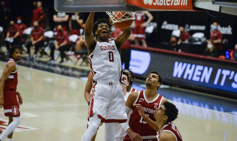 Freshman forward Efe Abogidi dunks the ball over Stanford defenders in the first overtime Saturday afternoon in Beasley Coliseum. The Cougars won in the third overtime 85-76.