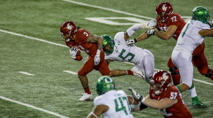 Redshirt senior running back Deon McIntosh attempts to shed an Oregon defender during the game against Oregon on Nov. 14 at Martin Stadium.