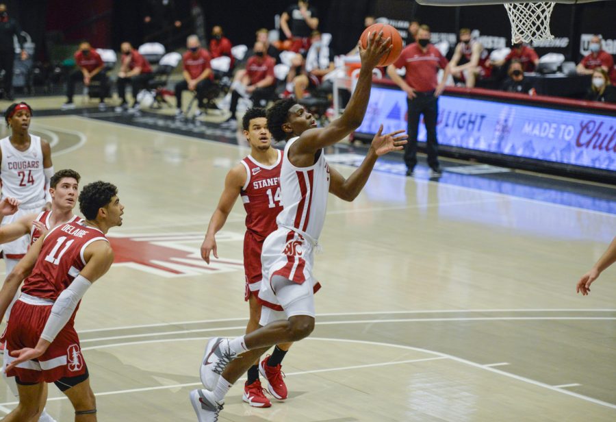 Freshman guard TJ Bamba drives to the hoop around a defender in hopes of a layup against Stanford on Feb. 20, 2021 in Beasley Coliseum.