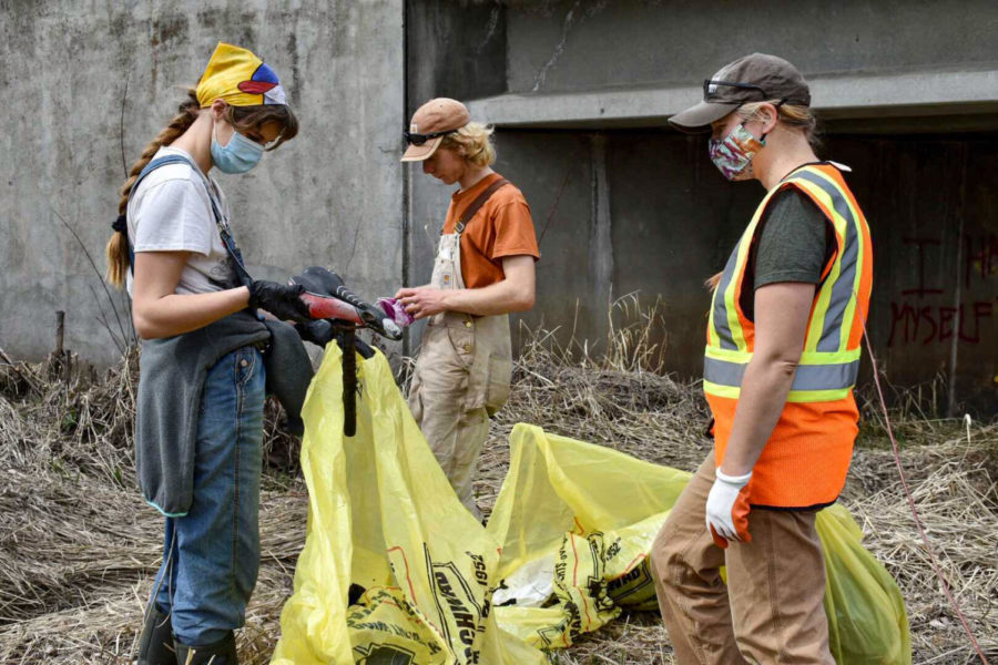 Savannah Reed (left), University of Idaho junior horticulture major, found a bicycle seat during the stream clean-up Saturday at the South Fork Palouse River.
