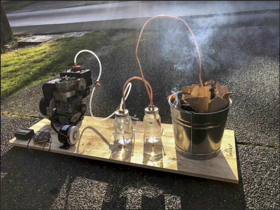 To+create+electricity%2C+the+students+built+a+system+that+burns+waste+and+collects+gas+to+convert+to+energy+in+the+jars.