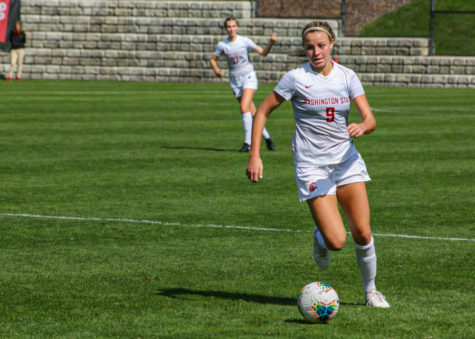 Senior midfielder Sydney Pulver dribbles the ball up the pitch as she looks for teammates.