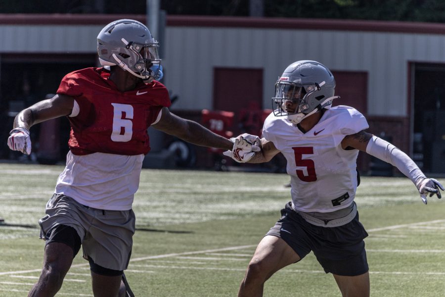 Redshirt sophomore receiver Donovan Ollie and senior defensive back Derrick Langford Jr. compete on a pass route during an Aug. 16 fall camp practice at Rogers Field in Pullman. 