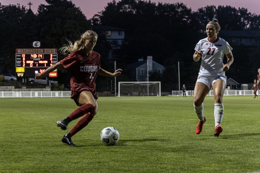 WSUs Grayson Lynch attempts a cross against Arkansas States Hannah Maupin in a Aug. 19 1-1 draw on the Lower Soccer Field. 