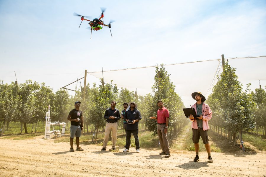 Anantharaman Kalyanaraman, computer science professor and lead principal investigator, and his team test an AI system at the demo research farm at a center in Prosser, Washington.