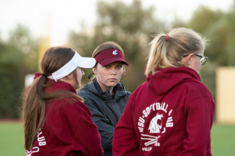 Washington State University Fastpitch Club member Mattie Mauseth glances up during a team meeting.  