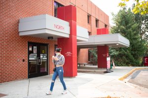 A student walks past the Cougar Health Services on the south side of campus.