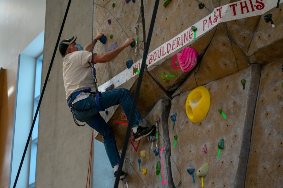 A participant in the Courageous Kids Climbing event climbs on the UREC climbing wall, Sunday, Sept. 26, 2021, in Pullman, WA.