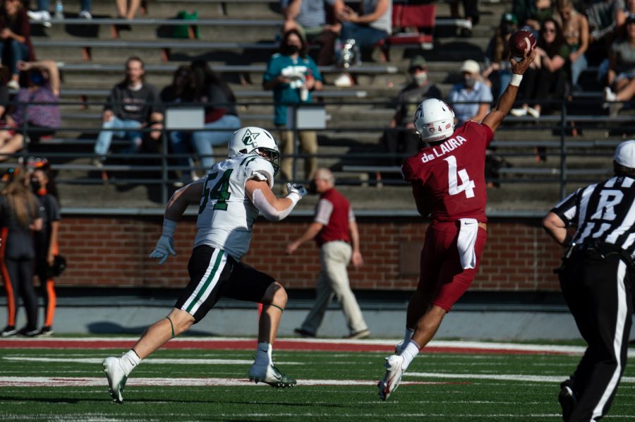 WSU quarterback Jayden de Laura scrambles and throws the ball against Portland State on Sept. 11, 2021.