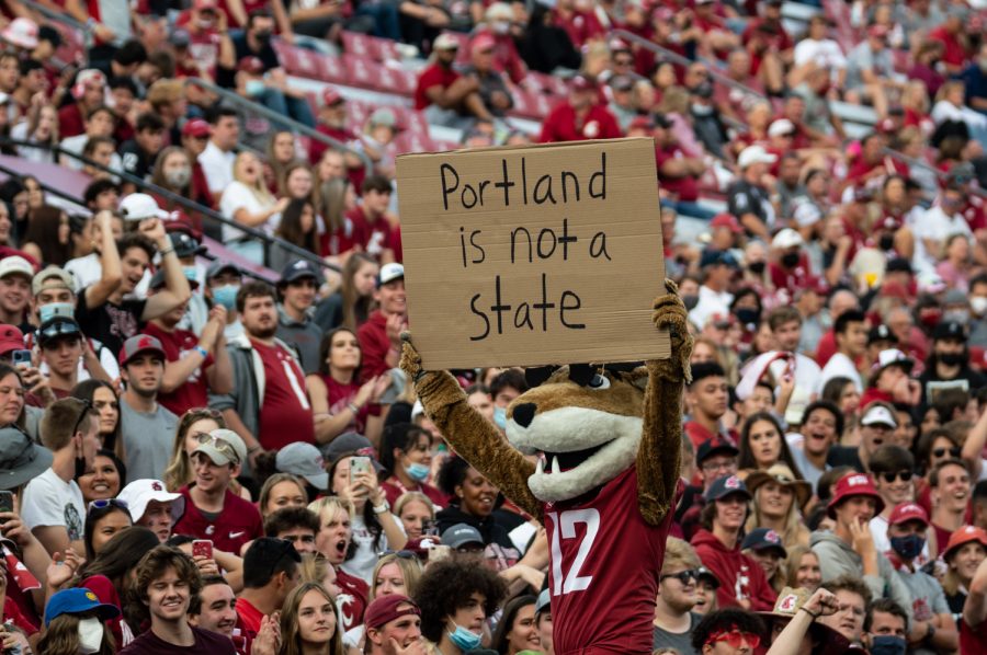 Butch the Cougar holds up a sign reading Portland is not a state in Martin Stadium on Sept. 11, 2021.