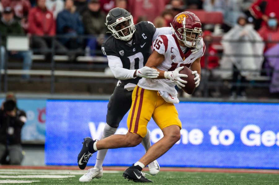 University of Southern California wide reciever Drake London (15) catches a pass while Washington State University defensive back Jaylen Watson (0) attempts to tackle him during the second half of a college football game, Saturday, Sept. 18, 2021, in Pullman, WA.