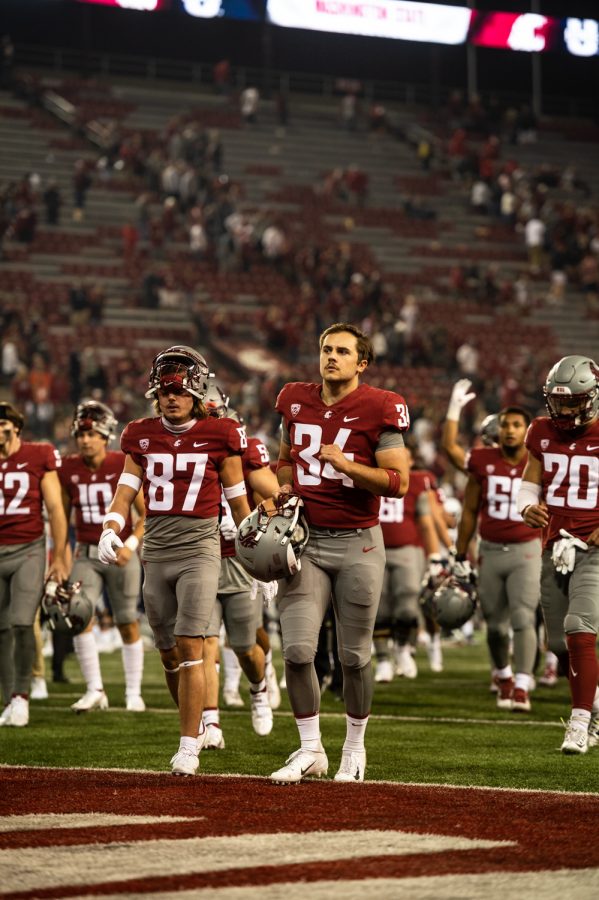 Washington State University players come off of the field after losing to Utah State 23-26 at Martin Stadium in Pullman, Wash., Saturday, Sept. 4, 2021. 