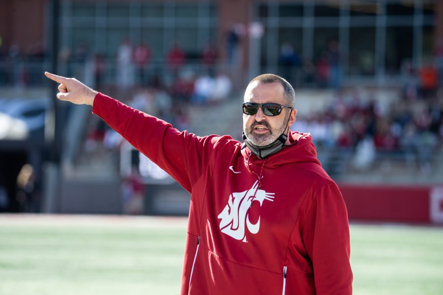 Nick Rolovich talks with a referee during a football game at Martin Stadium Oct. 9 in Pullman.
