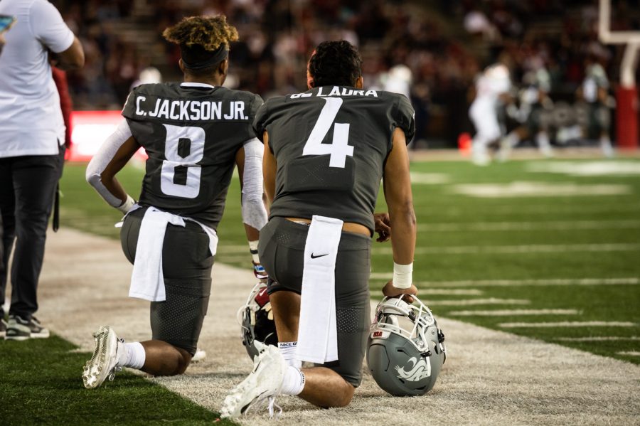 WSU wide reciever Calvin Jackson Jr. (8) and quarterback Jayden de Laura (4) watch the game from the sidleine during the second half of a college football game, Saturday, Oct. 16, 2021, at Martin Stadium in Pullman.