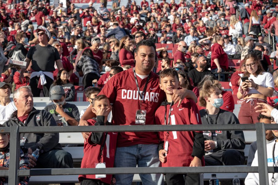 Michael, Maria and Payton watch the Cougars football game during Family Weekend, Satruday, Oct. 16, 2021, in Pullman, Wash.