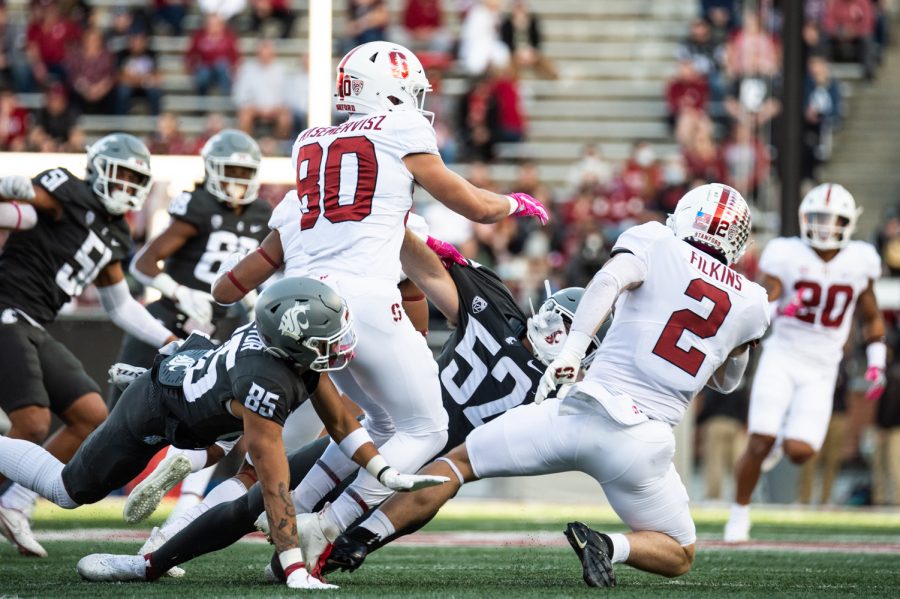 WSU wide reciever Lincoln Victor (85) and linebacker Kyle Thornton (52) attempt to tackle Stanford running back Casey Filkins on a punt return during the first half of a college football game on Oct. 16, 2021, at Martin Stadium.