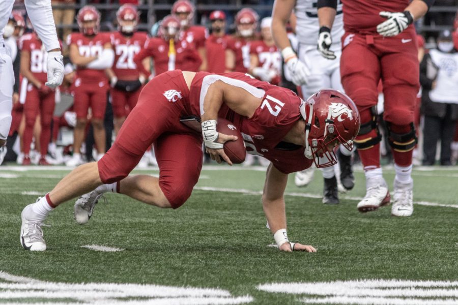 Washington State University wide reciever Joey Hobert (12) attempts to stay on his feet during the first half of a college football game at Martin Stadium, Saturday, Oct. 23, 2021, in Pullman, Wash.