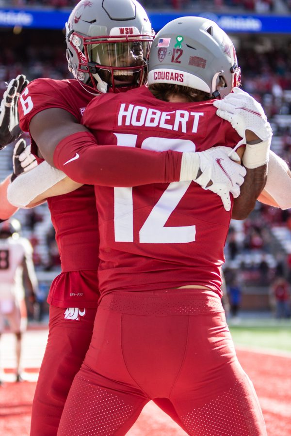 Washington State University wide recievers Joey Hobert (12) and Donovan Ollie (6) celebrate a touchdown during a college football game at Martin Stadium, Saturday, Oct. 9, 2021, in Pullman, Wash.