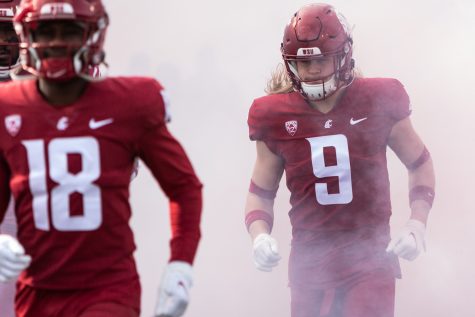 WSU linebacker Ben Wilson (9) runs out of the tunnel before a college football game on Oct. 23, at Martin Stadium in Pullman.