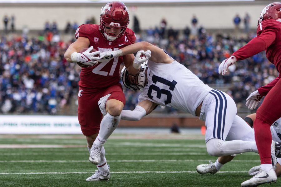 WSU running back Max Borghi (21) breaks away from BYU linebacker Max Tooley (31) during the second half of a college football game, Saturday, Oct. 23, 2021, at Martin Stadium in Pullman.