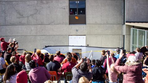 Spectators watch as 13 pumpkins are dropped from the 12th floor of the Webster Physical Science Building, Oct. 16, 2021.