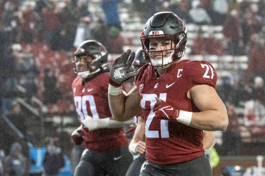 WSU running back Max Borghi (21) waves to camera while running onto the field before a college football game against the University of Arizona at Martin Stadium, Friday, Nov. 19, 2021, in Pullman, Wash.