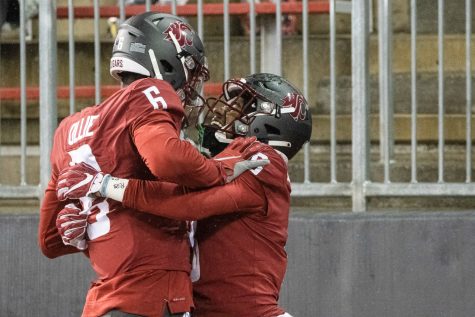 WSU wide receivers Donovan Ollie (6) and Calvin Jackson Jr. (8) celebrate after scoring a touchdown during a game against the University of Arizona at Martin Stadium, Nov. 19, 2021.
