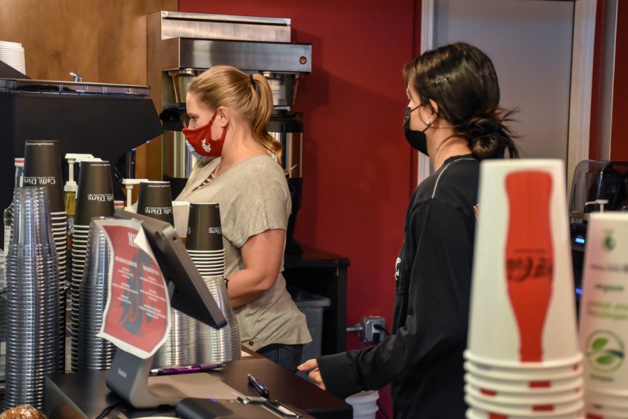 Heather Clark (left) brews coffee for students at the new Cougar Country Drive-In stand in the Compton Union Building, Monday, Nov. 1, 2021, in Pullman, Wash.