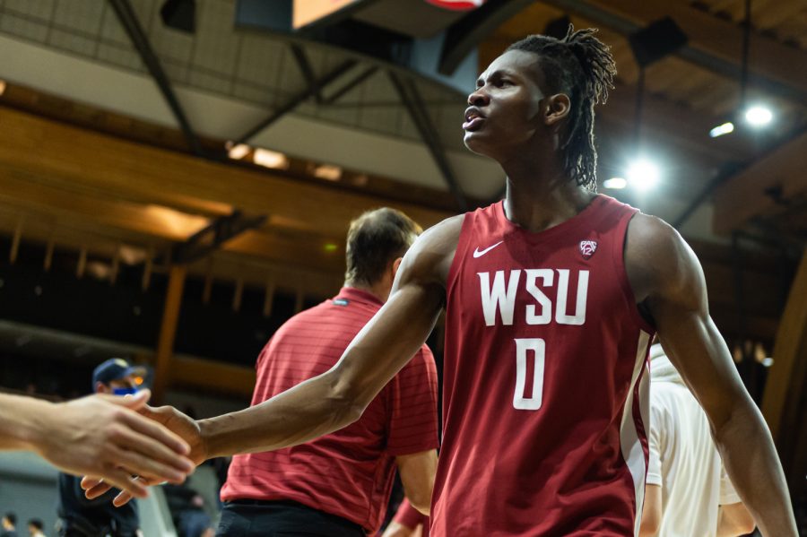 WSU forward Efe Abogidi (0) high-fives an athletic trainers hand after defeating the University of Idaho 109-61, Thursday, Nov. 18, 2021, in Moscow, Idaho.