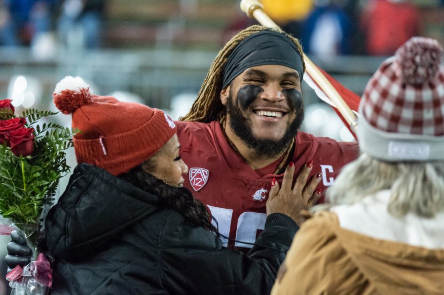 WSU wide reciever Calvin Jackson Jr. (8) celebrates with his family during senior recognitions before a college football game against the University of Arizona at Martin Stadium, Friday, Nov. 19, 2021, in Pullman, Wash.