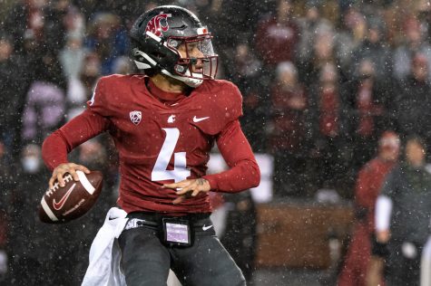 WSU quarterback Jayden de Laura (4) looks down field to throw the ball during a college football game against the University of Arizona at Martin Stadium, Friday, Nov. 19, 2021.