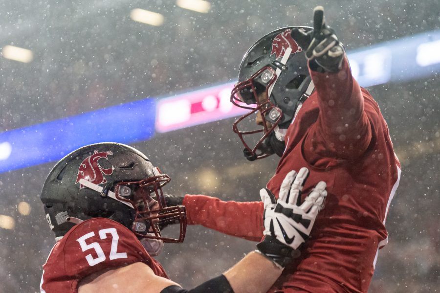 WSU wide receiver Travell Harris (1) celebrates with offensive lineman Jarrett Kingston (52) after a touchdown during a college football game against the University of Arizona at Martin Stadium, Friday, Nov. 19, 2021, in Pullman, Wash.