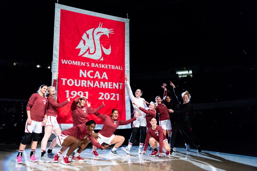 The+WSU+womens+basketball+team+celebrates+the+rising+of+their+new+banner+Tuesday+in+Pullman.+The+banner+recognized+the+teams+nomination+to+play+in+the+NCAA+Tournament+during+the+2021+season.
