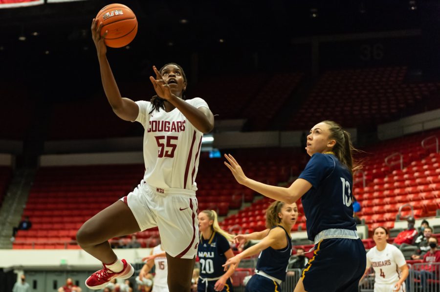 WSU center Bella Murekatete (55) jumps for a layup during a college basketball game against Northern Arizona University at Beasley Coliseum, Friday, Nov. 12, 2021, in Pullman.