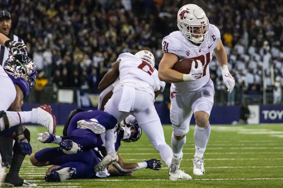 WSU running back Max Borghi (21) runs to the endzone during the Apple Cup, Friday, Nov. 26, 2021, at Husky Stadium in Seattle.