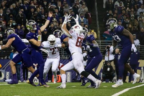 WSU defensive edge Brennan Jackson (80) tries to block a pass from UW quarterback Sam Huard (7) during the Apple Cup, Friday, Nov. 26, 2021, at Husky Stadium in Seattle.