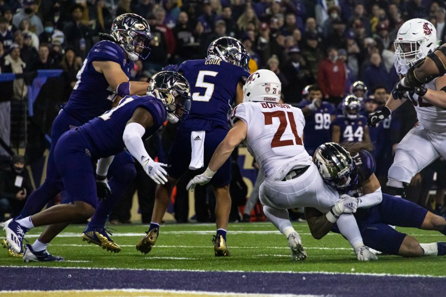 WSU running back Max Borghi (21) dives for the endzone during the Apple Cup at Husky Stadium, Friday, Nov. 26, 2021, in Seattle.