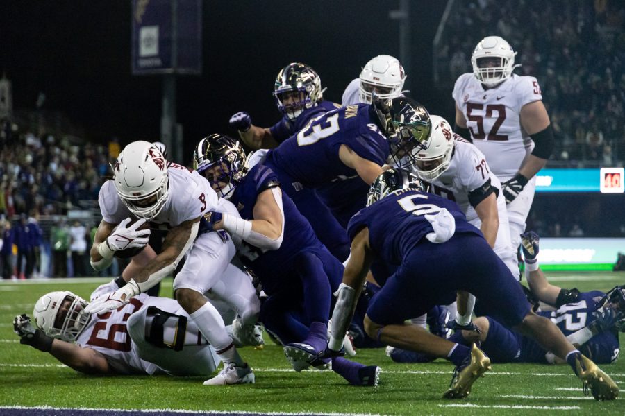 WSU running back Deon McIntosh (3) dives for the endzone during the Apple Cup, Friday, Nov. 26, 2021, at Husky Stadium in Seattle.