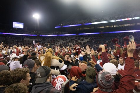 WSU fans rush the field at Husky Stadium after WSU beat UW 40-13 in the Apple Cup, Friday, Nov. 27, 2021, in Seattle.