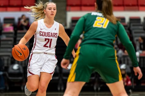 WSU guard Johanna Teder (21) dribbles the ball towards the basket during a college basketball game against the University of San Francisco in Beasley Coliseum, Dec. 3, 2021, in Pullman.