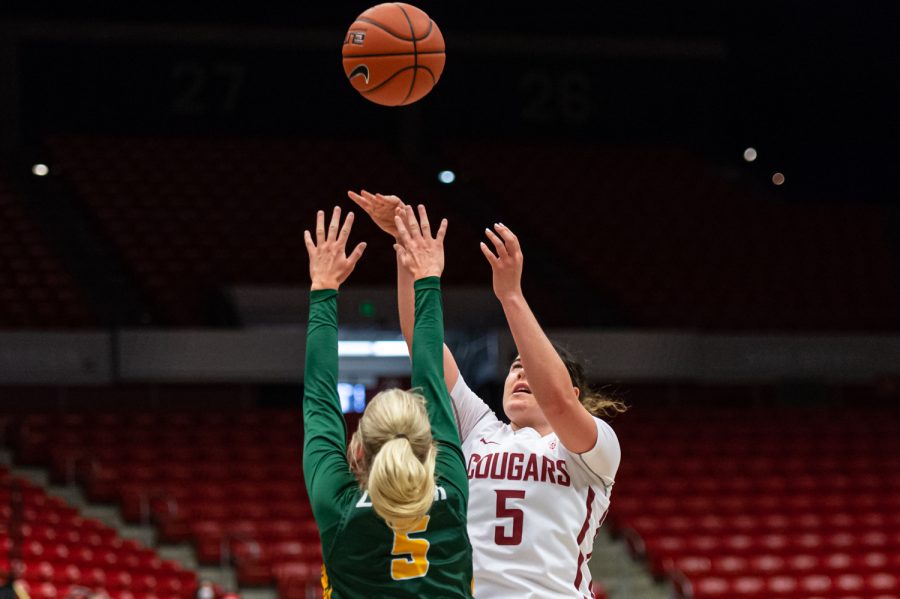 WSU guard Charlisse Leger-Walker (5, right) shoots a three-pointer during a college basketball game against the University of San Francisco in Beasley Coliseum, Dec. 3, 2021.