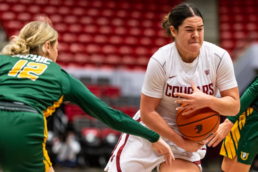 WSU guard Charlisse Leger-Walker protects the ball while running up for a layup during a college basketball game against the University of San Francisco in Beasley Colliseum, Dec. 3, 2021, in Pullman, Wash.