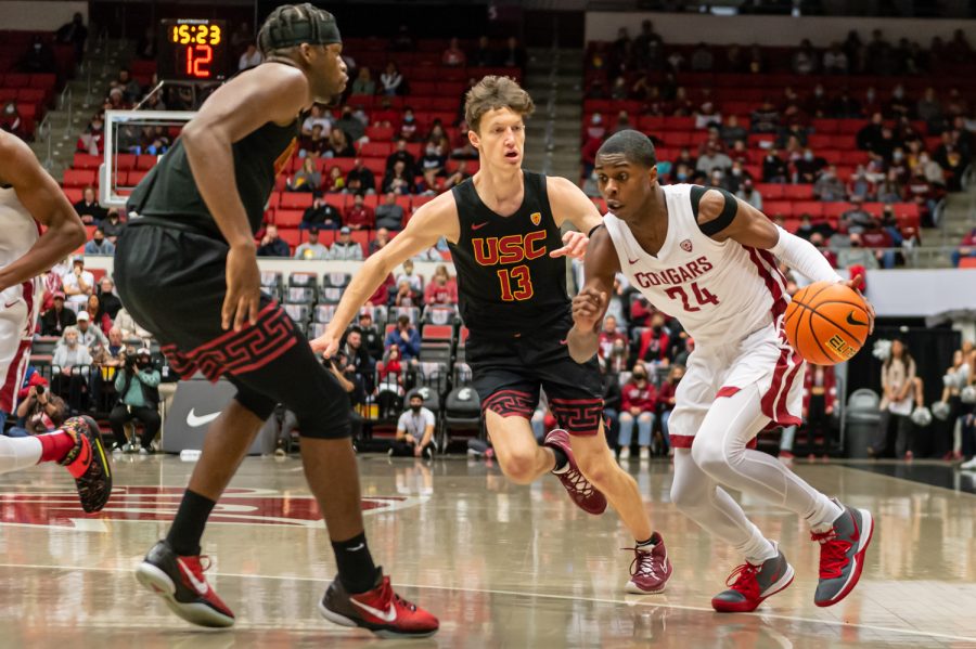WSU guard Noah Williams (24) dribbles the ball toward the basket during a college basketball game against the University of Southern California at Beasley Coliseum, Saturday in Pullman.