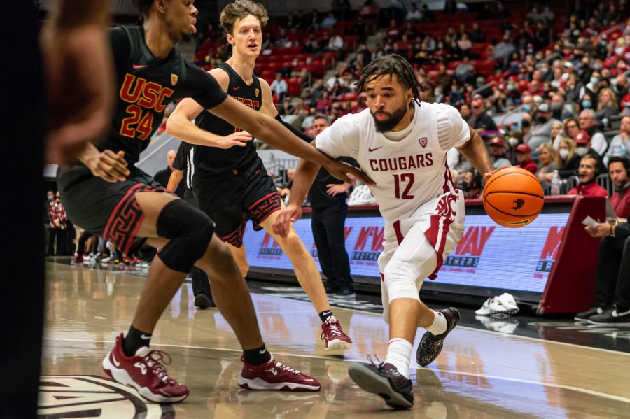 WSU guard Michael Flowers (12) dribbles towards the basket during a college basketball game against the University of Southern California at Beasley Coliseum, Saturday, Dec. 4, 2021, in Pullman, Wash.