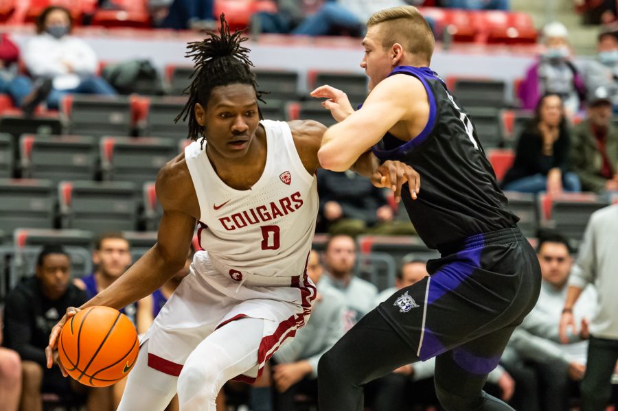 WSU forward Efe Abogidi (0) dribbles the ball toward the basket during a college basketball game against Weber State University at Beasley Coliseum, Wednesday, Dec. 8, 2021, in Pullman.