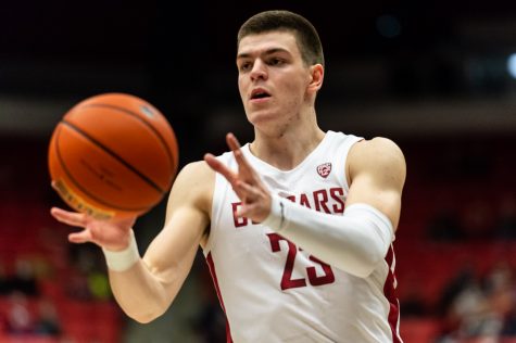 WSU forward Andrej Jakimovski (23) passes the ball during a college basketball game against Weber State University at Beasley Coliseum, Wednesday, Dec. 8, 2021.