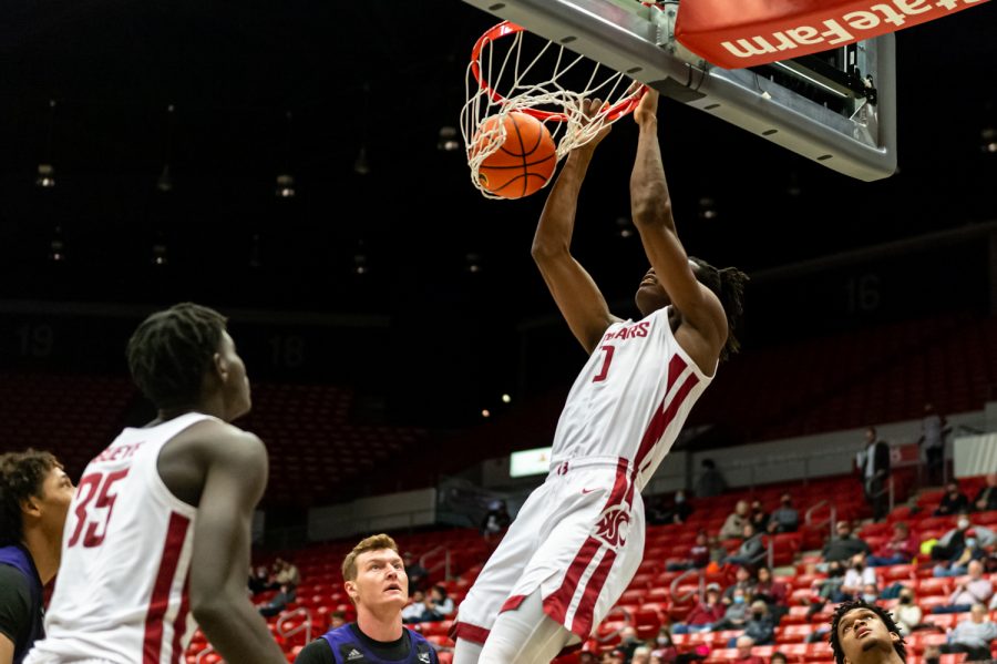 WSU+forward+Efe+Abogidi+%280%29+dunks+the+ball+during+a+college+basketball+game+against+Weber+State+University+at+Beasley+Coliseum%2C+Wednesday%2C+Dec.+8%2C+2021%2C+in+Pullman.